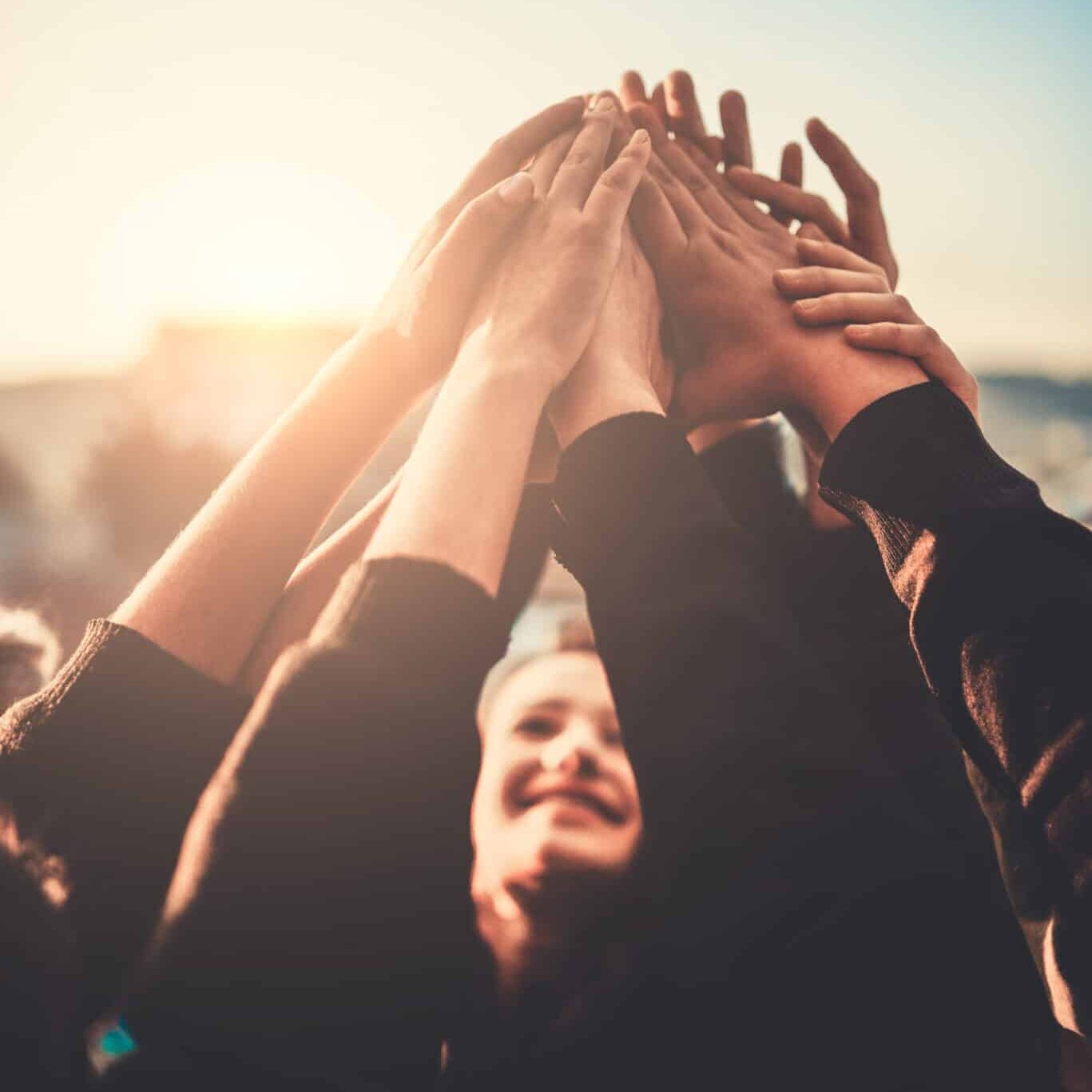 Group of Teenagers Volunteer with Raised Hands to the Sky.